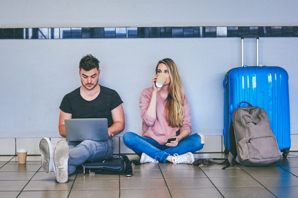 couple sitting on airport floor